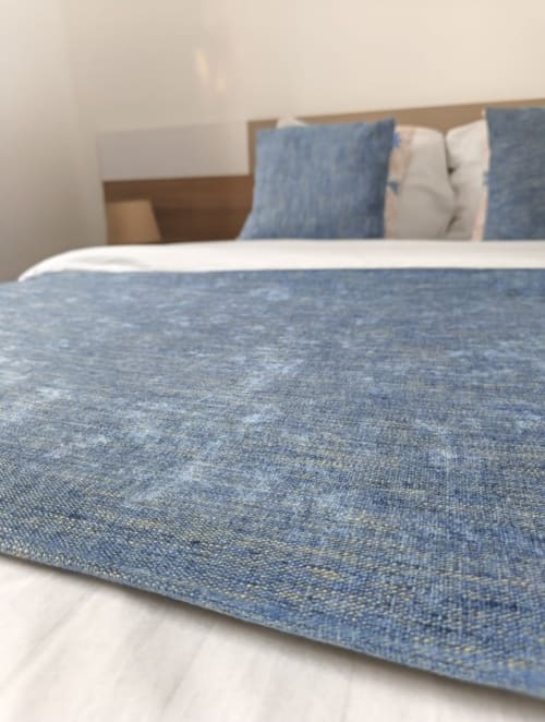 Literie et oreillers texturés bleus dans la chambre de la villa La Villa des Pins Filao à Akanda, Gabon