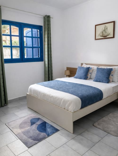 Chambre moderne de la villa La Villa des Pins à Akanda avec fenêtres à cadre bleu, décor nautique et ambiance côtière