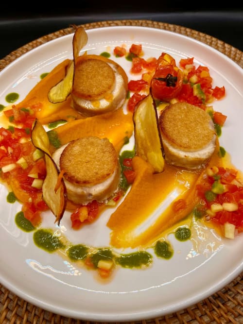 Elegant plated scallops with seared crusts, roasted peppers, and herb reduction at OPOA Beach Hôtel, Uturoa