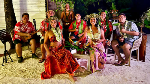 Group performing Hawaiian music and dance on beach at Opoa Beach Hôtel in Uturoa, French Polynesia