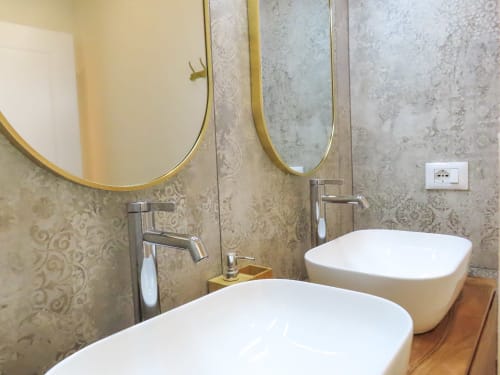 Luxury bathroom in Verona with dual vessel sinks, gold-framed mirrors, and damask wallpaper in Suite Superior n. 202