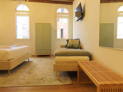 Modern suite in Verona with yellow walls, contemporary furniture, arched windows, river view, and flat-screen TV