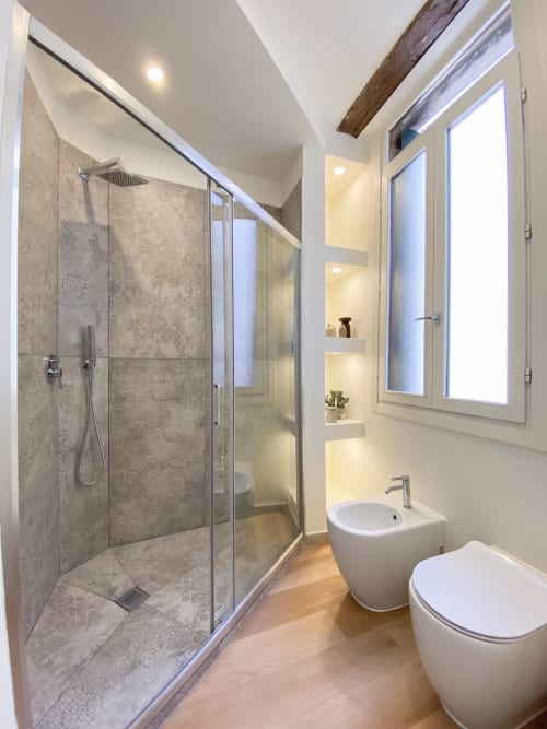 Luxury bathroom with walk-in shower, bidet, sink and heated towel rack at San Marco Suites in Verona