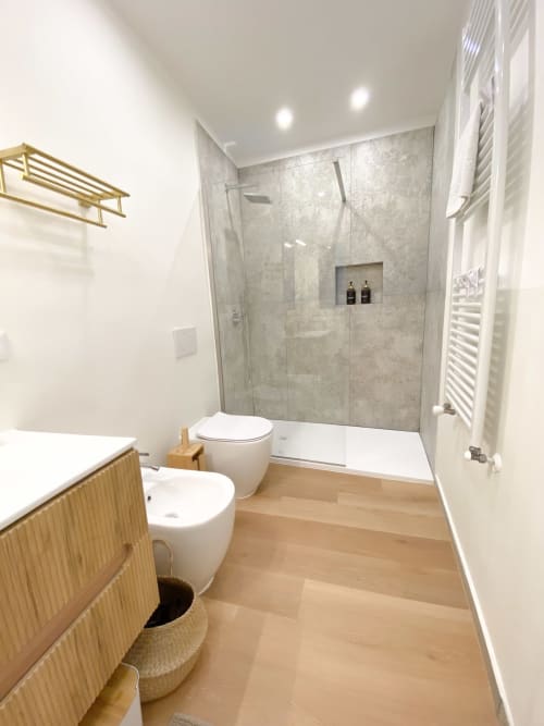 Modern bathroom in San Marco Luxury Suites, Verona with walk-in shower, white fixtures, wooden vanity, and heated towel rack