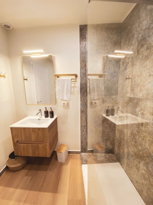 Modern luxury bathroom in San Marco Superior Suite, Verona, with wooden vanity, gold fixtures, heated towel rails, and