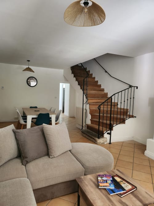 Spacious living area in Clairette cottage at Domaine De Poulharies, Carcassonne, with lounge, dining area, wooden stairs and