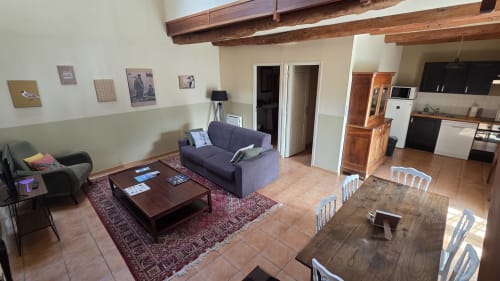 Le Surcouf apartment at Manoir de la Bégaudière with living area, dining table, and kitchen in Mont-Dol