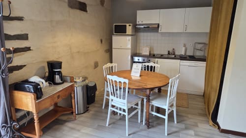 Kitchen and dining area in Le Chateaubriand apartment at Manoir de la Bégaudière, Mont-Dol