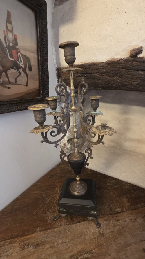 Antique brass candelabra with five candle holders displayed in Le Jacques Cartier apartment at Manoir de la Bégaudière,
