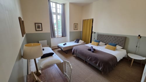 Le Jacques Cartier apartment at Manoir de la Bégaudière, Mont-Dol with twin beds, lounge area, and garden views
