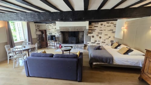 Le Duguay Trouin apartment at Manoir de la Bégaudière in Mont-Dol with bed, sofa, fireplace and garden views