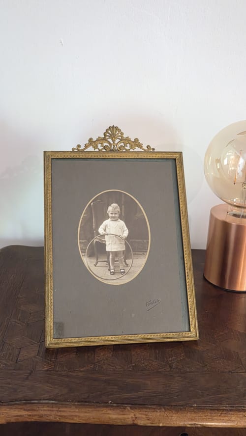 Vintage portrait of child in ornate gold frame at Manoir de la Bégaudière, Mont-Dol