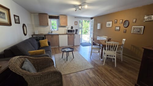 Le De Kerguelen apartment at Manoir de la Bégaudière in Mont-Dol, open-plan living space with kitchen, dining area, and