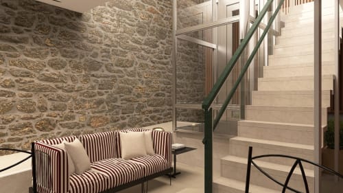 Modern B&B room at Feel Sintra with striped sofa, stone walls, and staircase in Sintra, Portugal