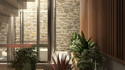Modern bedroom with stone walls, potted plants, and city views at Feel Sintra boutique hotel in Sintra, Portugal