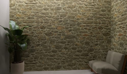 Rustic stone wall seating area at Feel Sintra boutique hotel in Portugal with modern chair and potted plant