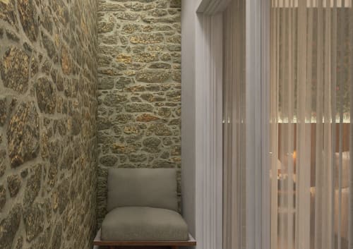 Cozy seating nook at Feel Sintra with stone walls, cream cushioned chair, and sheer curtains in Sintra, Portugal