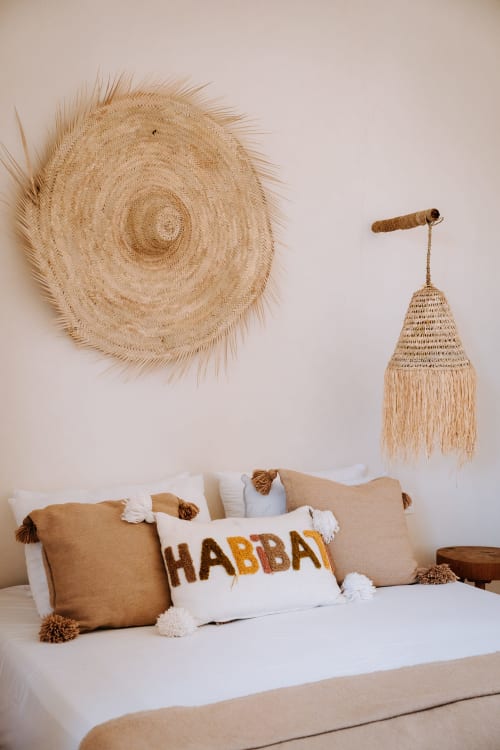 Boheme Supérieur room at Eucalyptus Ethnic hotel featuring woven wall art, tassel pillows, and Moroccan-inspired decor in