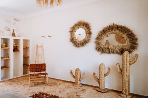 Bohemian room at Eucalyptus Ethnic hotel in Essaouira with woven mirrors, straw cacti, and natural décor