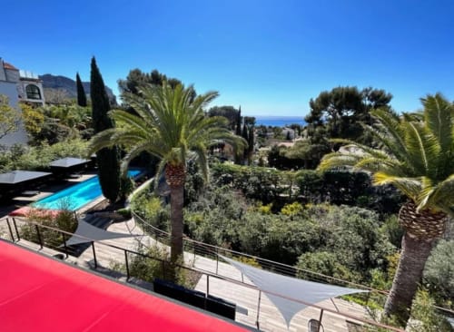 Villa Annette terrace with pool, palm trees, and Mediterranean Sea views in French Riviera