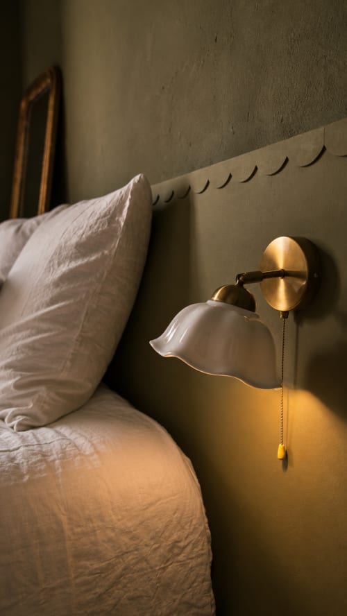 Bedside reading lamp with brass fixture in Peacock room at La Maison 1903 B&B, Trévou-Tréguignec