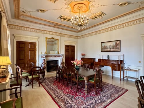 Elegant formal dining room at Domaine de Bize Mirepoix with chandelier, fireplace, and period furniture