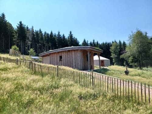 Hébergement traditionnel en yourte à La Yourte Un Autre Monde au Hohwald, entouré de forêt de montagne et de clôtures en bois