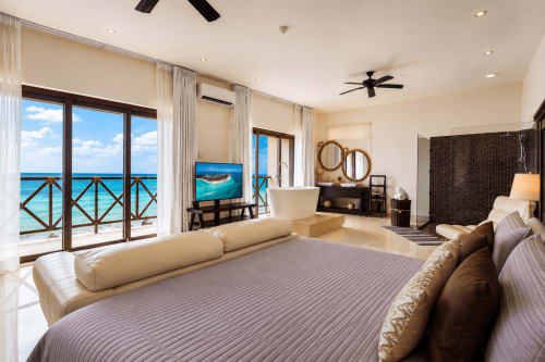 Luxury oceanfront bedroom at Casa Javi Isla Mujeres with turquoise sea views, king bed, modern amenities, and beachfront