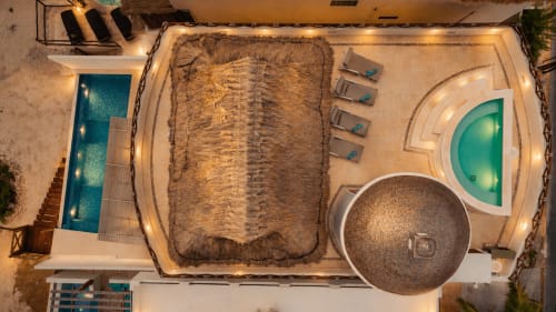 Aerial view of Casa Javi oceanfront cottage in Isla Mujeres with pools, hot tub, lounge chairs, and beach access