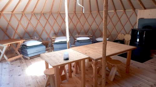 Intérieur de yourte à La Yourte Un Autre Monde au Hohwald avec lits en bois, table à manger et lumière naturelle