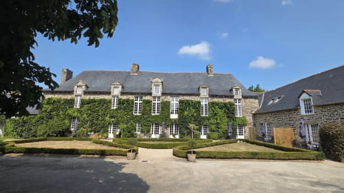 Manoir de la Bégaudière, ivy-covered stone manor house B&B in Mont-Dol, France with courtyard