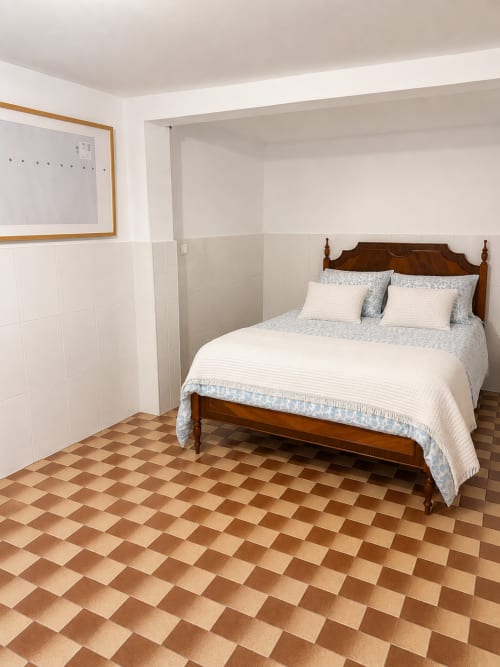 Family Loft bedroom at Villas Simone Porto Santo with wooden bed, white bedding, and terracotta tile floor