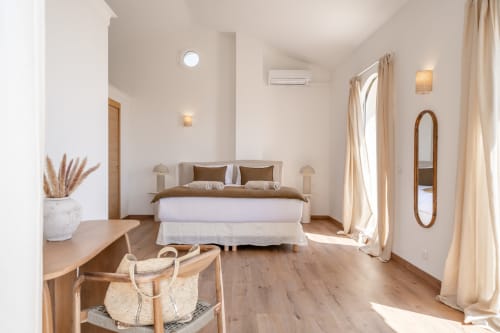 Bright bedroom in Villa M de Mas-Piscine villa in Grasse with wooden floors, king bed, desk, and terrace access