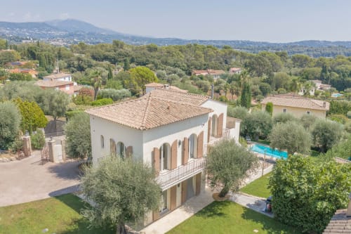 Aerial view of Villa M de Mas in Grasse with terracotta roof, arched windows, private pool, and surrounding Provence