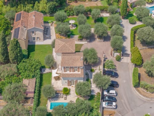 Aerial view of Villa M de Mas in Grasse with private pool, terracotta roofs, manicured gardens and olive trees near