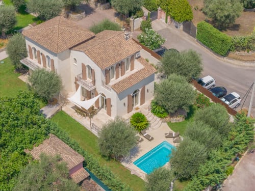 Aerial view of M Résidences villa with terracotta roof, private pool, manicured gardens and olive trees