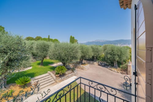 M Résidences balcony view overlooking olive grove garden with mountain landscape