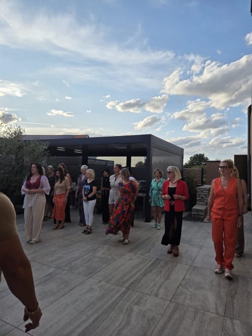Group of guests gathering on rooftop terrace at Hôtel-Restaurant le S'Y in Seingbouse, France under blue sky