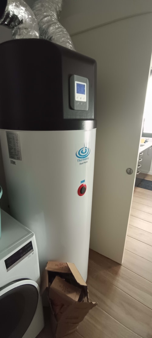 Thermeau heat pump water heater in apartment at Pés Verdes Hostel, Ponta Delgada with digital control panel and ducting above