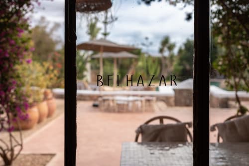 Belhazar boutique hotel courtyard in Essaouira with pool view, gardens, and covered seating area
