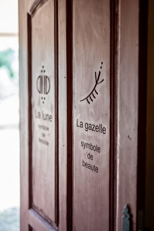Wooden door with 'La gazelle' branding and eyelash symbol at Domaine Belhazar, Essaouira