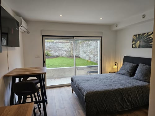 Studio Mirabeau 2 chambres avec vue sur jardin aux Lodges de Barbieux, Croix, avec lit, bureau et portes-fenêtres