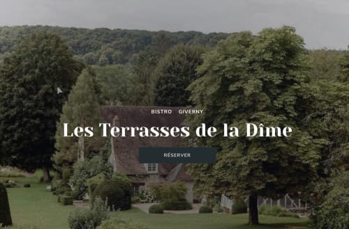 Les Terrasses de la Dime bistro in La Roche Guyon, France with lush grounds and ivy-covered stone building