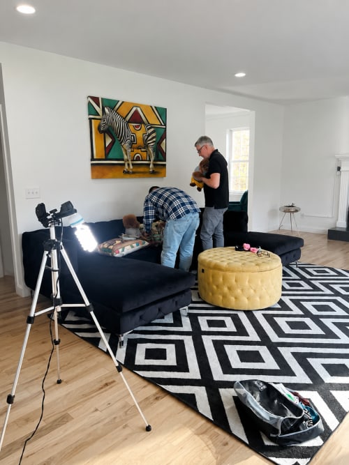 Family playing with dog in modern living room at Malkita Homes, Highland Mills