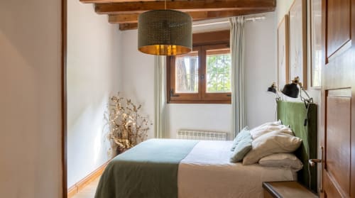 Dormitorio Cerezo en El Aserradero de La Alberca con vigas de madera, lámpara colgante, vistas al jardín y cómoda ropa de cama