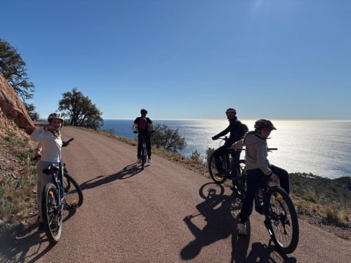 Four cyclists on coastal path overlooking Mediterranean Sea near Cagnes-sur-Mer, France