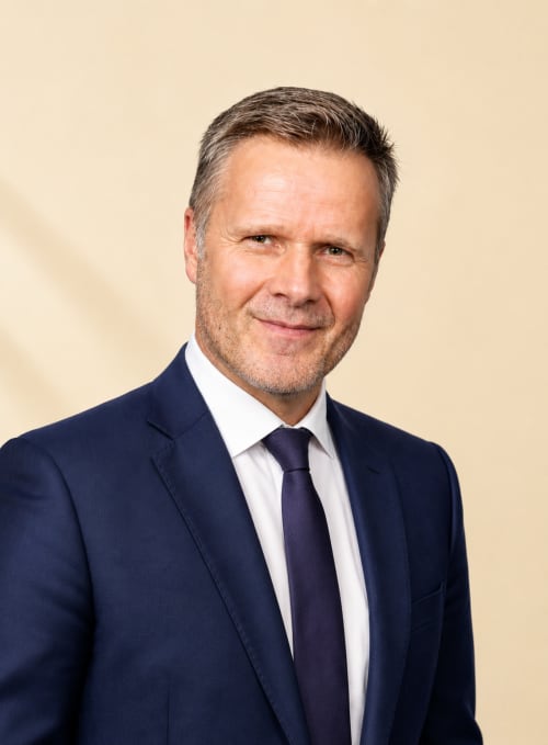 Professional male property manager at Mattbnblux1 hotel in Luxembourg wearing navy suit and tie