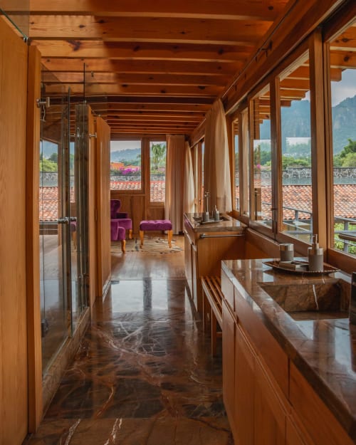 Luxurious wooden master suite at La Hacienda Tepoztlan with mountain views, terrace, and purple furnishings