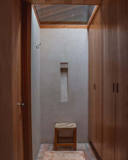 Minimalist wooden corridor with skylight at La Hacienda Tepoztlan, Tepoztlán - rustic woven stool and storage niches