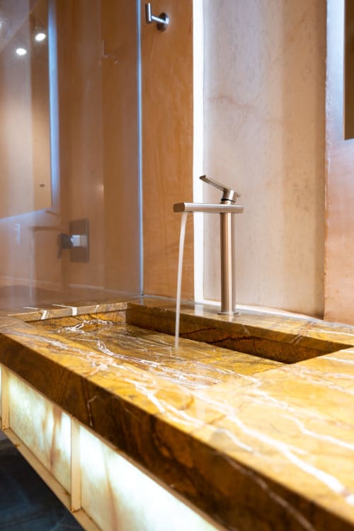 Luxurious marble bathroom sink at La Hacienda Tepoztlan, Tepoztlán with modern faucet and shower enclosure